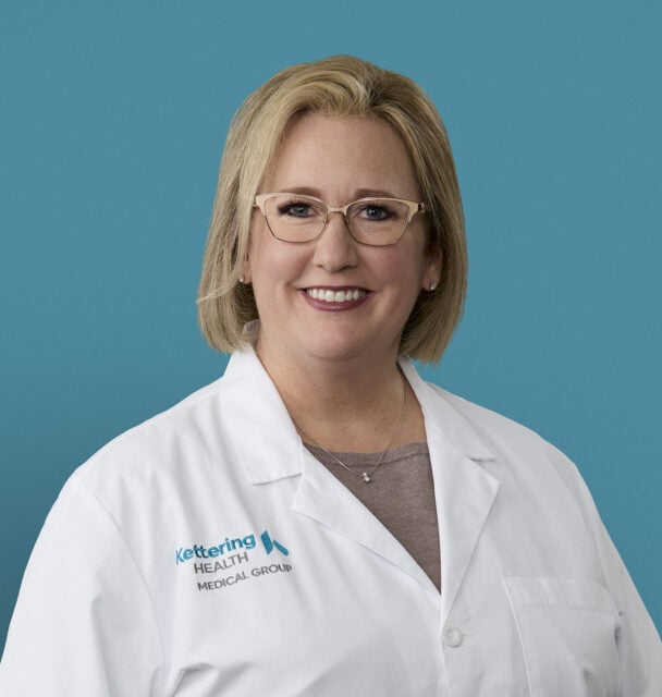 Professional headshot of Heather Campbell, APRN-CNP in white medical coat