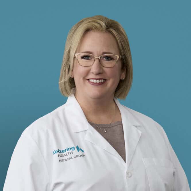 Professional headshot of Heather Campbell, APRN-CNP in white medical coat