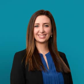 Professional headshot of Hilary Haley, APRN-CNP in black blazer and blue blouse