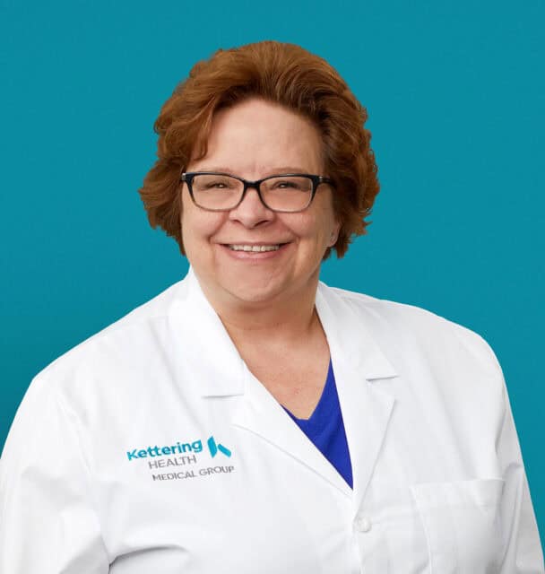 Professional headshot of Jackie R. Isaacs, APRN-CNP in white Kettering Health coat