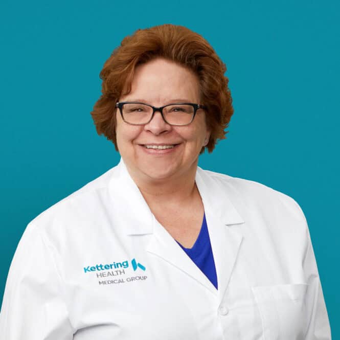 Professional headshot of Jackie R. Isaacs, APRN-CNP in white Kettering Health coat