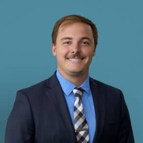 Professional headshot of Jacob Dickman, MD in dark suit and blue shirt smiling