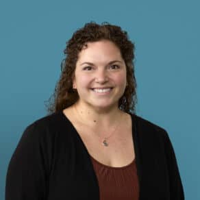 Professional headshot of Jenny Ingle, APRN-CNP, smiling against blue background
