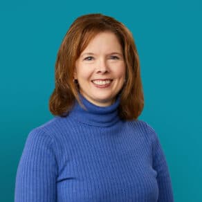 Professional headshot of Jessica Roten, PharmD wearing blue turtleneck sweater against teal background