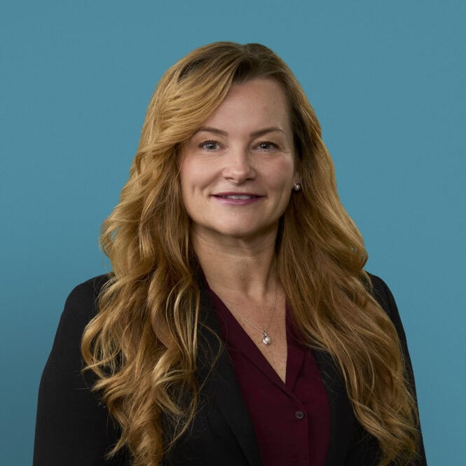Professional headshot of Julie Hall, APRN-CNP, wearing dark blazer and burgundy blouse