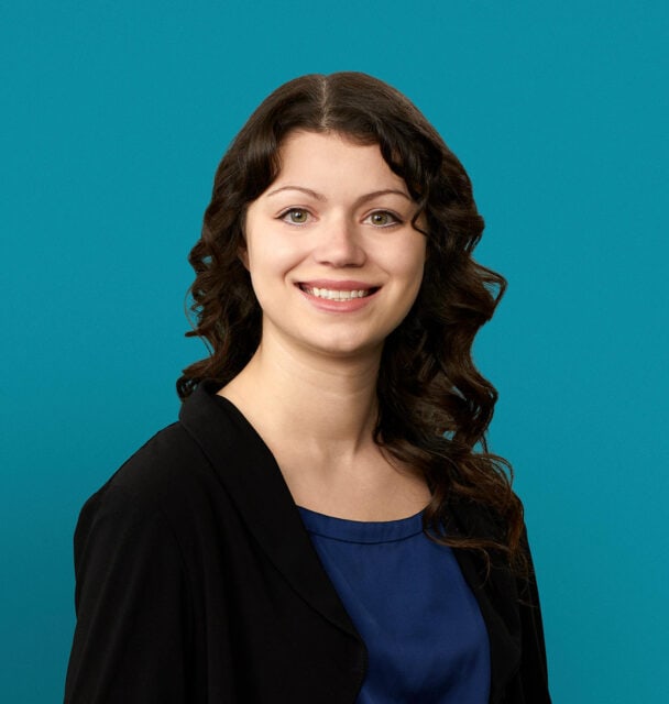 Professional headshot of Kaitlin Lange, PA-C, smiling woman in black blazer and blue top