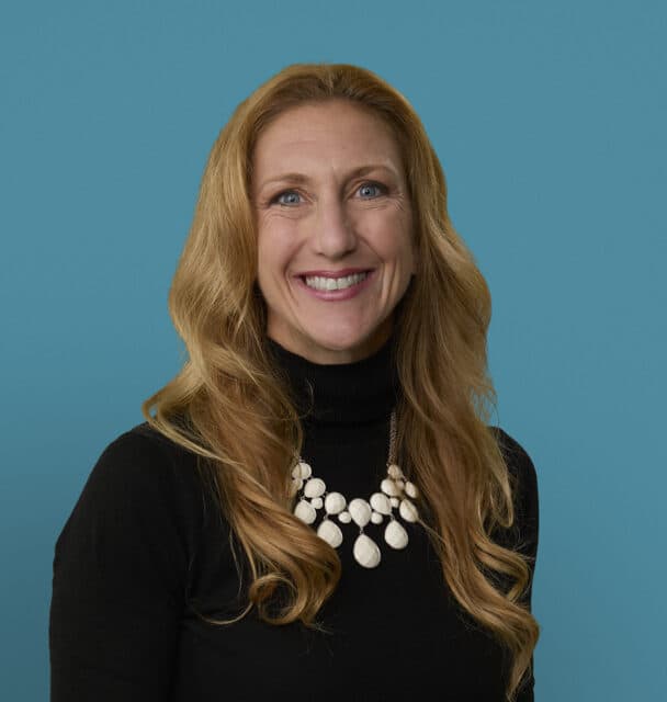 Professional headshot of Katie Crowder, MD smiling in black top with white necklace