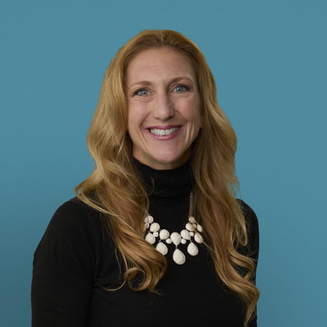 Professional headshot of Katie Crowder, MD smiling in black top with white necklace