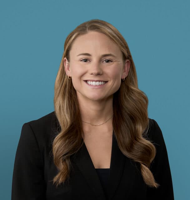 Professional headshot of Katie Zellers, PA-C in black blazer against blue background