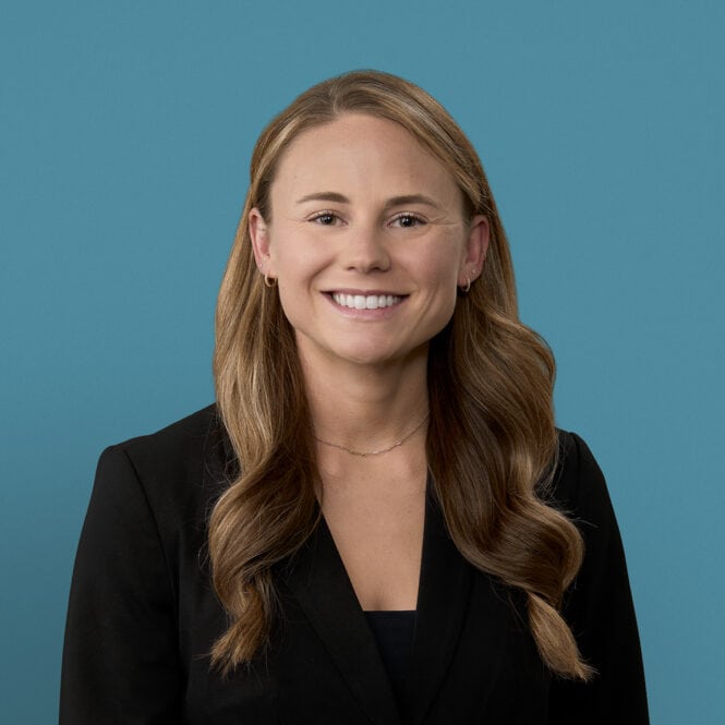Professional headshot of Katie Zellers, PA-C in black blazer against blue background