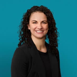 Professional headshot of Kayli D. Johnson, APRN-CNP, smiling in dark blazer against teal background.