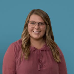 Professional headshot of Kaysea Sonterre, APRN-CNP, smiling woman with glasses wearing burgundy blouse