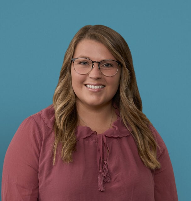 Professional headshot of Kaysea Sonterre, APRN-CNP, smiling woman with glasses wearing burgundy blouse