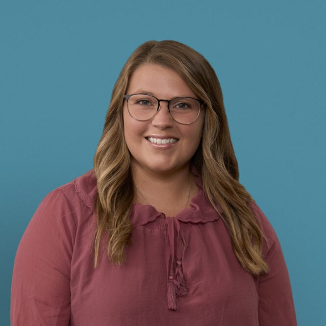 Professional headshot of Kaysea Sonterre, APRN-CNP, smiling woman with glasses wearing burgundy blouse