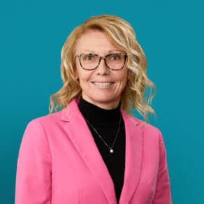 Professional headshot of Kelly L. Miller, MD wearing pink blazer and glasses