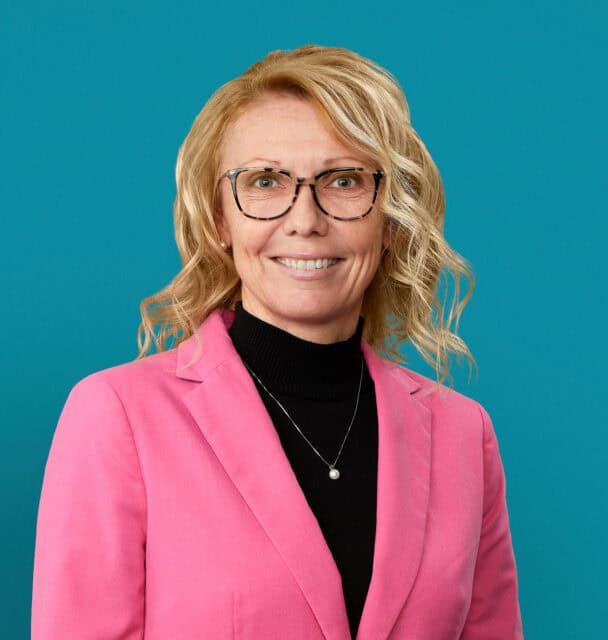 Professional headshot of Kelly L. Miller, MD wearing pink blazer and glasses