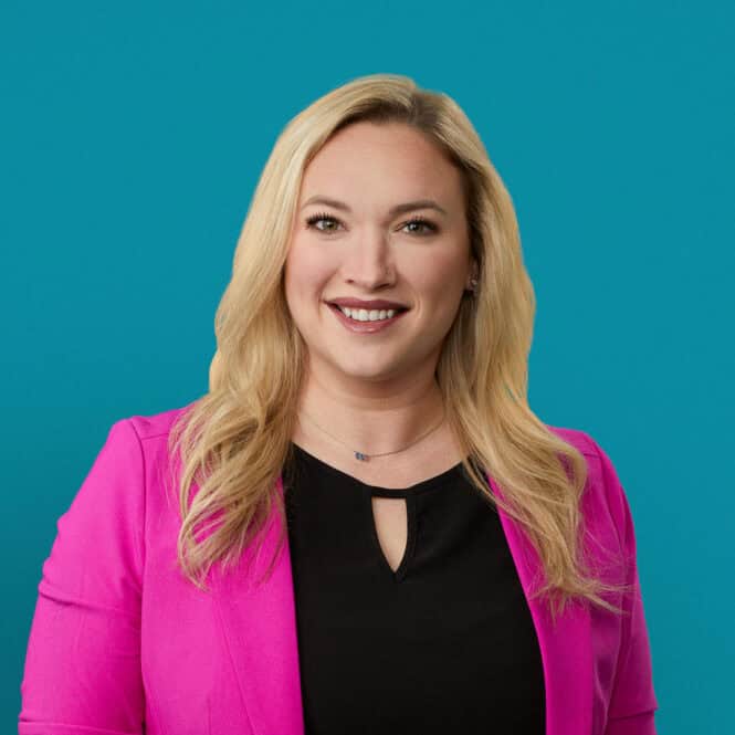 Professional headshot of Kelsey Matthews, PA-C in bright pink blazer smiling at camera