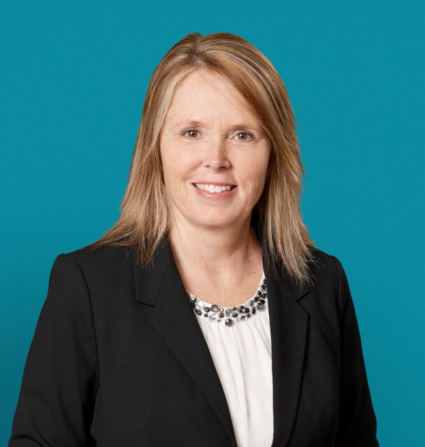 Professional headshot of Kimberly A. Bell, APRN-CNP in dark blazer against teal background