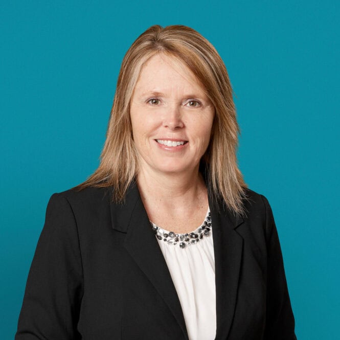 Professional headshot of Kimberly A. Bell, APRN-CNP in dark blazer against teal background