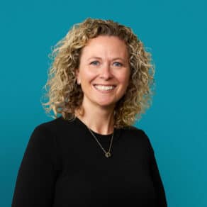 Professional headshot of Kimberly Parker-Maloney, APRN-CNP, smiling in black sweater against blue background
