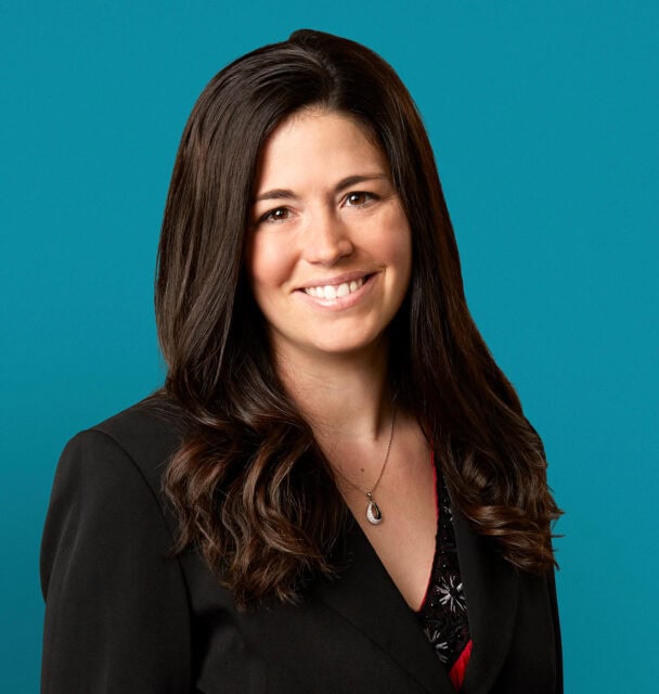 Professional headshot of Laura A. Busteed, APRN-CNP against teal background