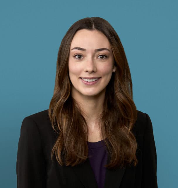 Professional headshot of Lily Whiteside, PA-C, smiling in dark blazer against blue background
