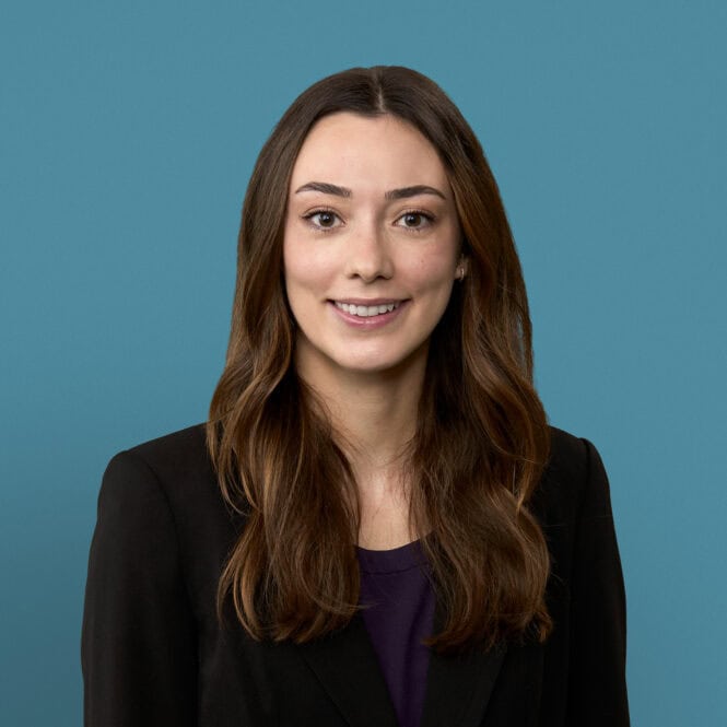 Professional headshot of Lily Whiteside, PA-C, smiling in dark blazer against blue background