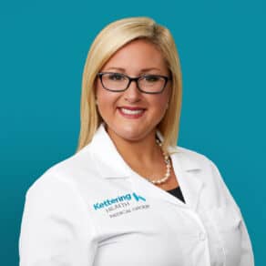 Professional headshot of Lisa N. Lane, nurse practitioner in white coat with pearl necklace
