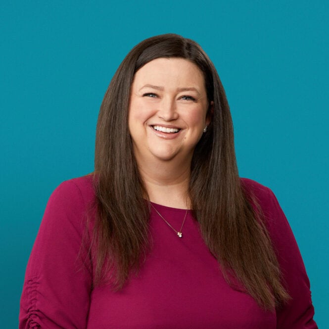 Professional headshot of Lori A. Washing, APRN-CNP in maroon top against teal background