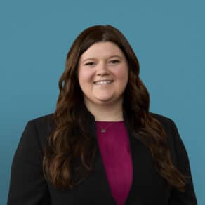 Professional headshot of Madysen Acra, PA-C in black blazer and purple top