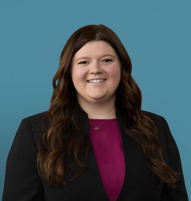Professional headshot of Madysen Acra, PA-C in black blazer and purple top