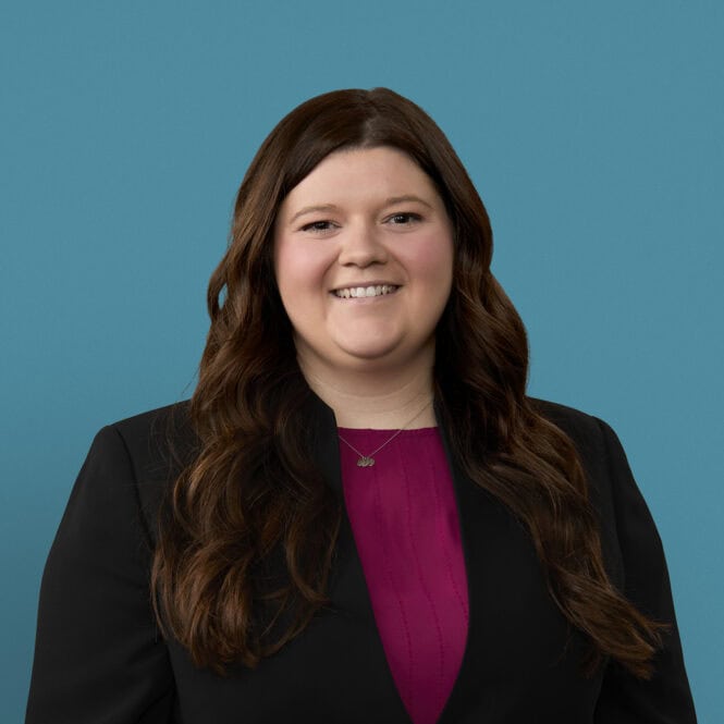 Professional headshot of Madysen Acra, PA-C in black blazer and purple top
