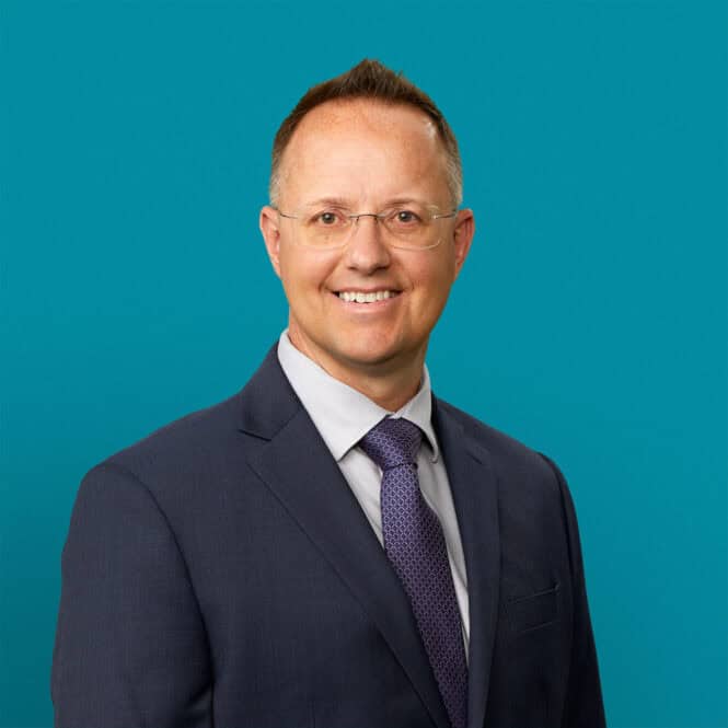 Professional headshot of Marcus P. Bolton, APRN-CNP in business suit against teal background