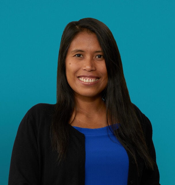 Professional headshot of Dr. Maritess G. Asumen wearing black blazer and blue top