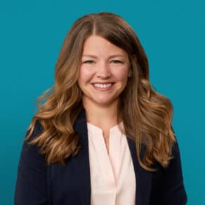 Professional headshot of Megan Kuertz, APRN-CNP, smiling in business attire against teal background.