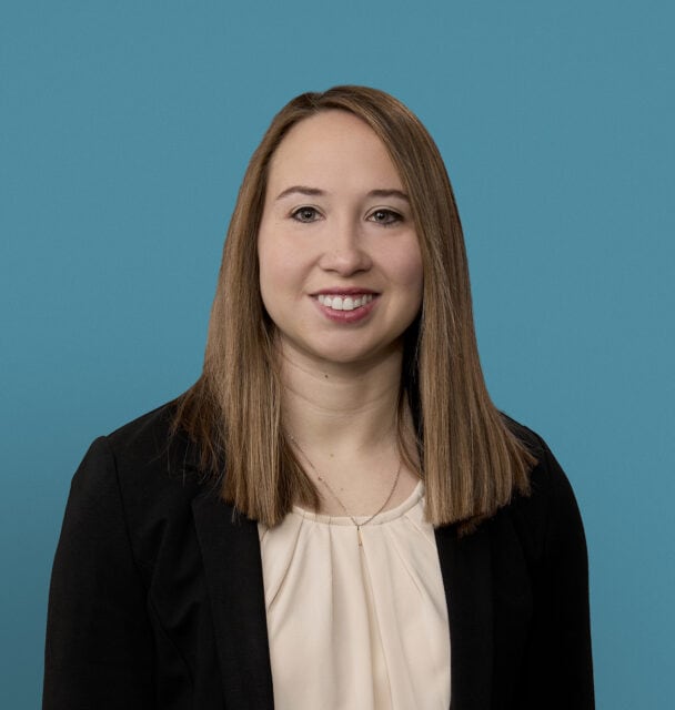 Professional headshot of Megan Wright, PA-C smiling in business attire against blue background