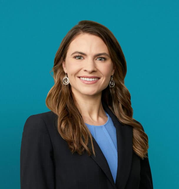 Professional headshot of Dr. Michelle F. Barrord in dark blazer against teal background