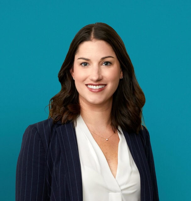 Professional headshot of Michelle N. Bonnet, MD in navy blazer against teal background