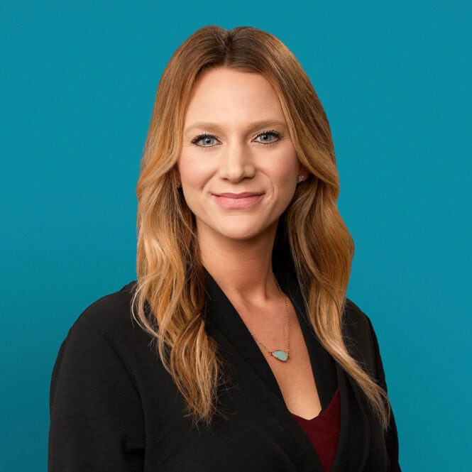 Professional headshot of Mindy Kahlhamer, APRN-CNP in black blazer against teal background