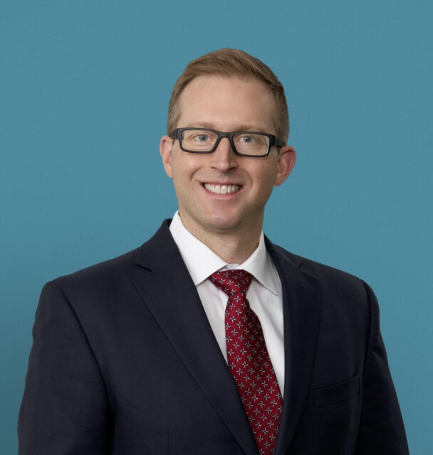 Professional headshot of Dr. Phillip M. Porcelli in dark suit with red tie