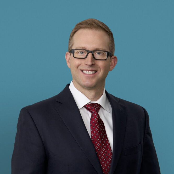Professional headshot of Dr. Phillip M. Porcelli in dark suit with red tie
