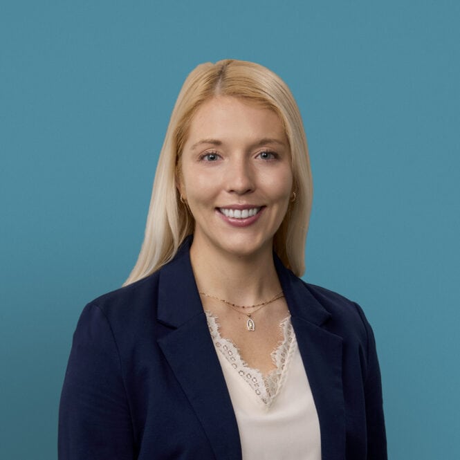 Professional headshot of Rachael Bauer, PA-C in navy blazer against teal background