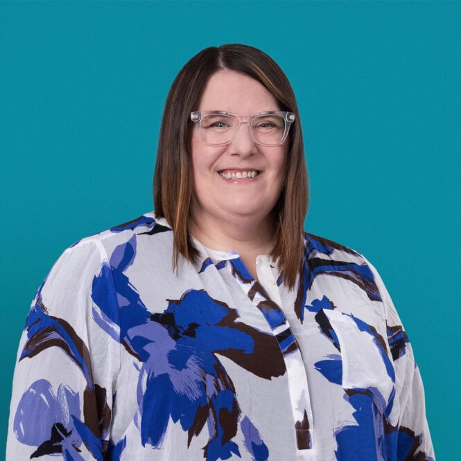 Professional headshot of Rachel Bird, APRN-CNP, smiling woman with glasses and floral blouse