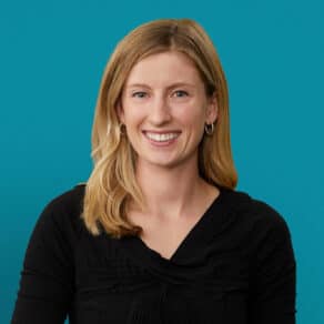 Professional headshot of Rachel Booth, DO smiling in black top against teal background