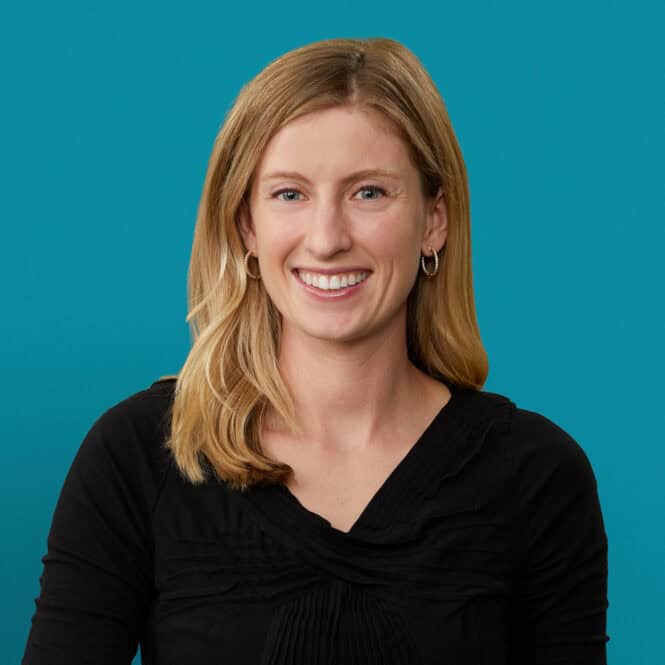 Professional headshot of Rachel Booth, DO smiling in black top against teal background