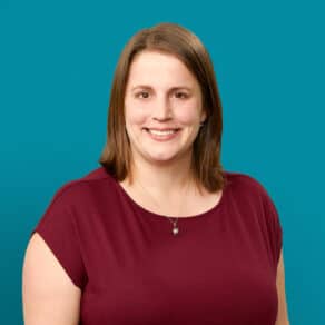 Professional headshot of Rachel S. June, MD smiling in burgundy top against teal background