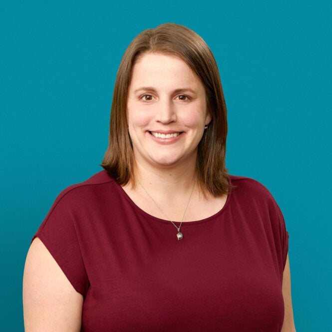 Professional headshot of Rachel S. June, MD smiling in burgundy top against teal background
