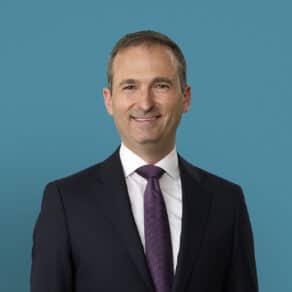 Professional headshot of Ralph E. Vatner, MD in dark suit with purple tie