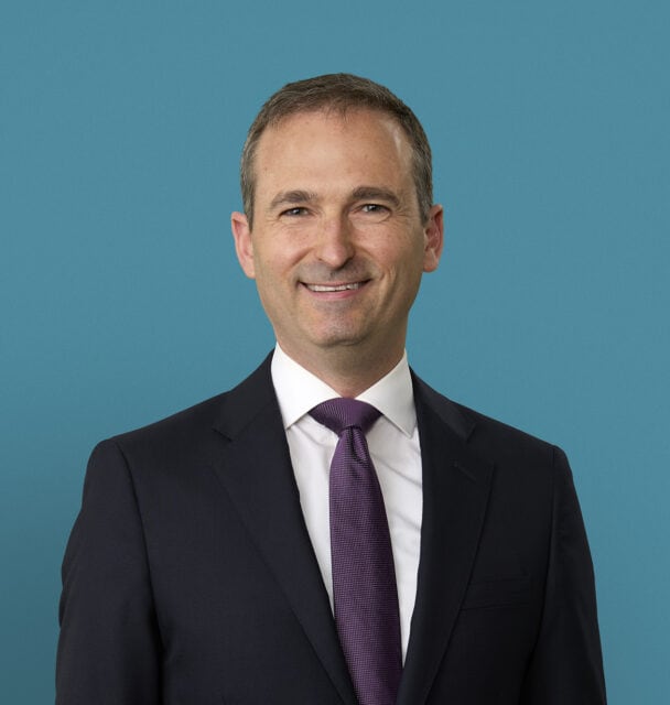Professional headshot of Ralph E. Vatner, MD in dark suit with purple tie