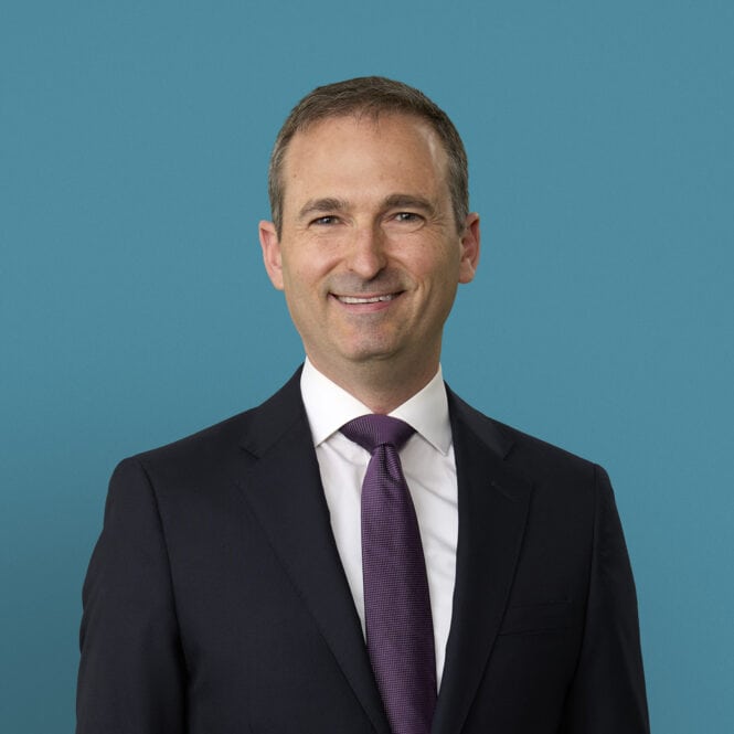 Professional headshot of Ralph E. Vatner, MD in dark suit with purple tie